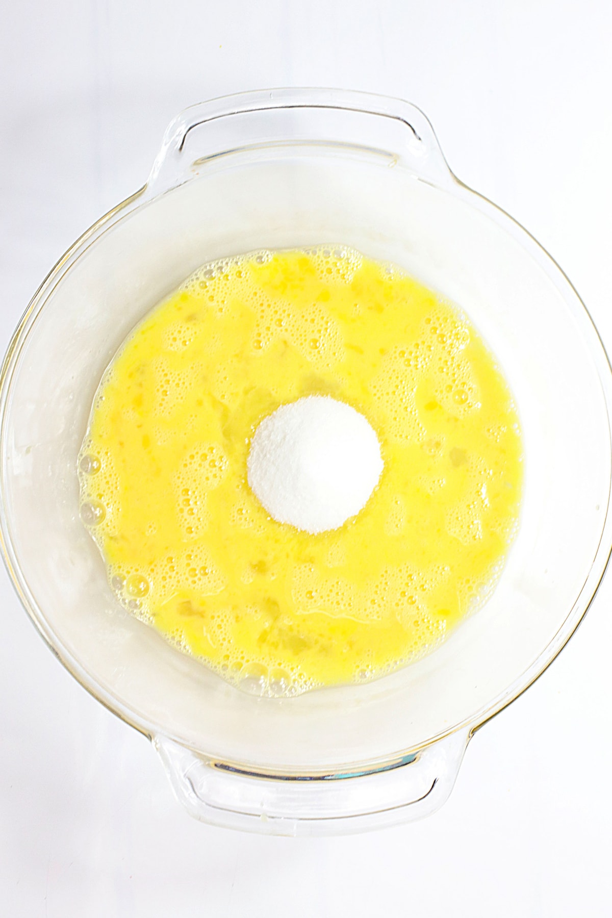 Eggs in bowl with sugar