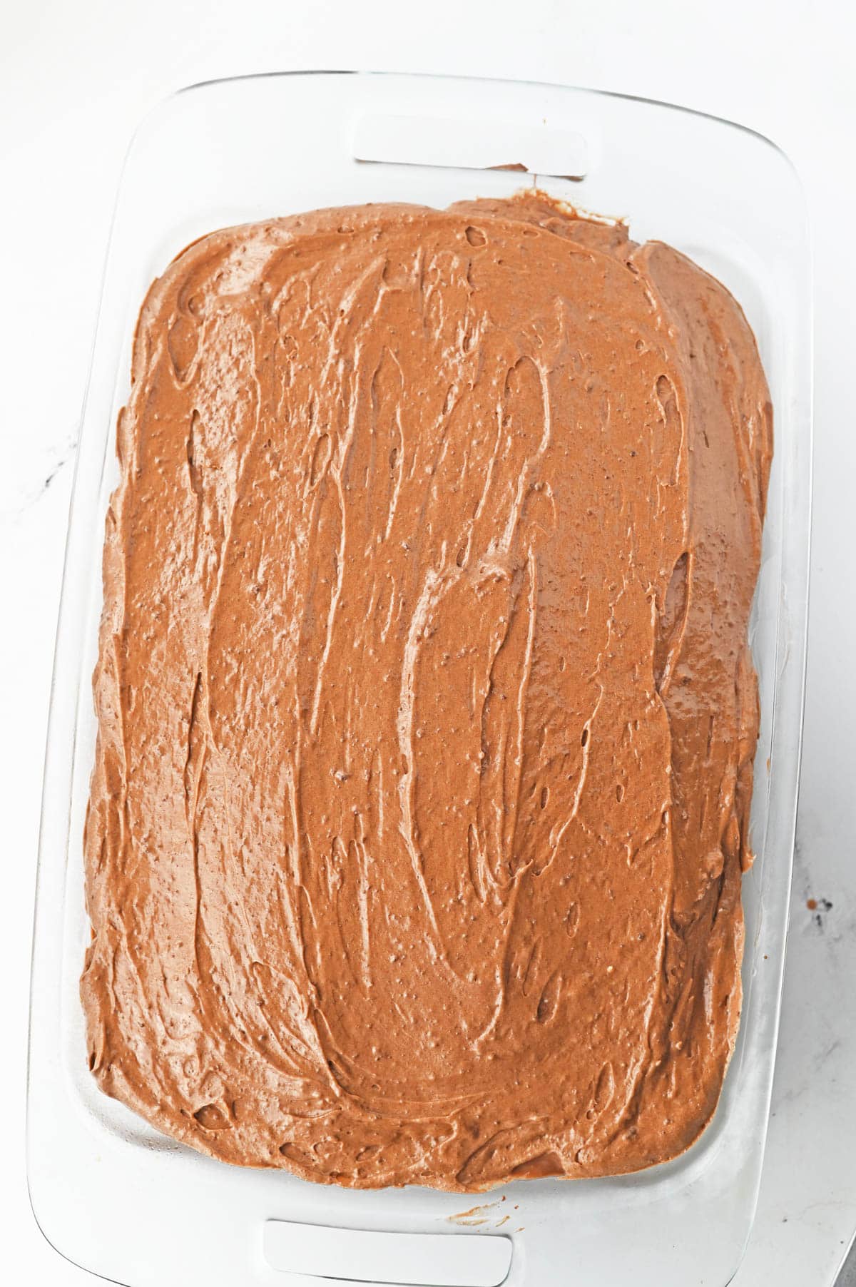 Chocolate poke cake with chocolate frosting