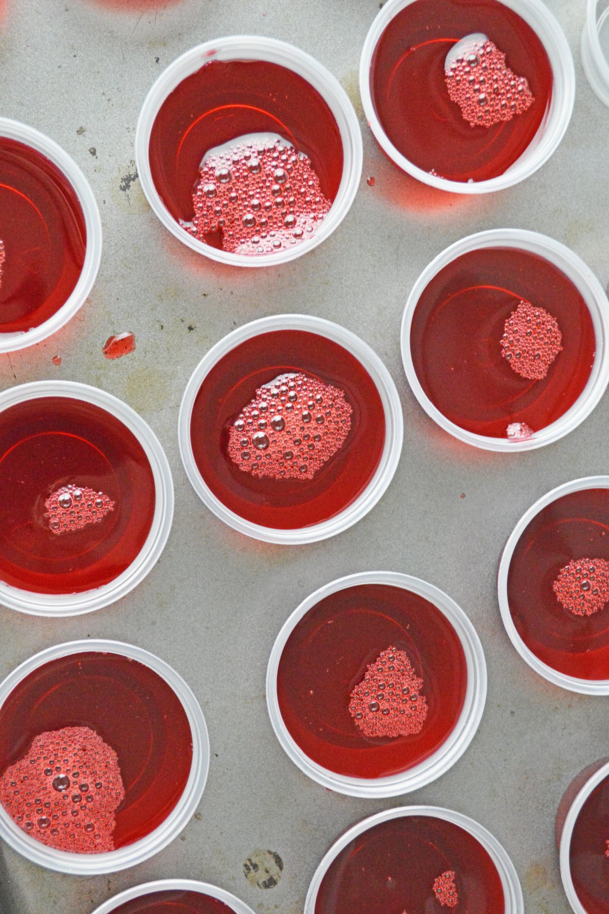 Cranberry Jello mixture poured into shot cups