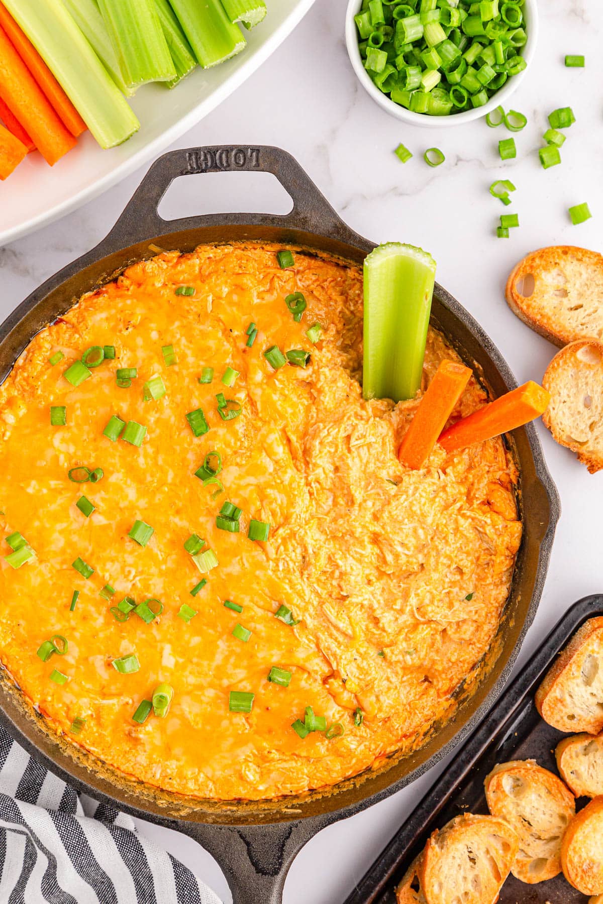 Buffalo chicken dip with celery and carrot sticks