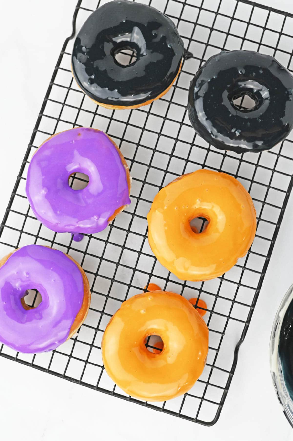Donuts dipped in orange, purple and black glaze