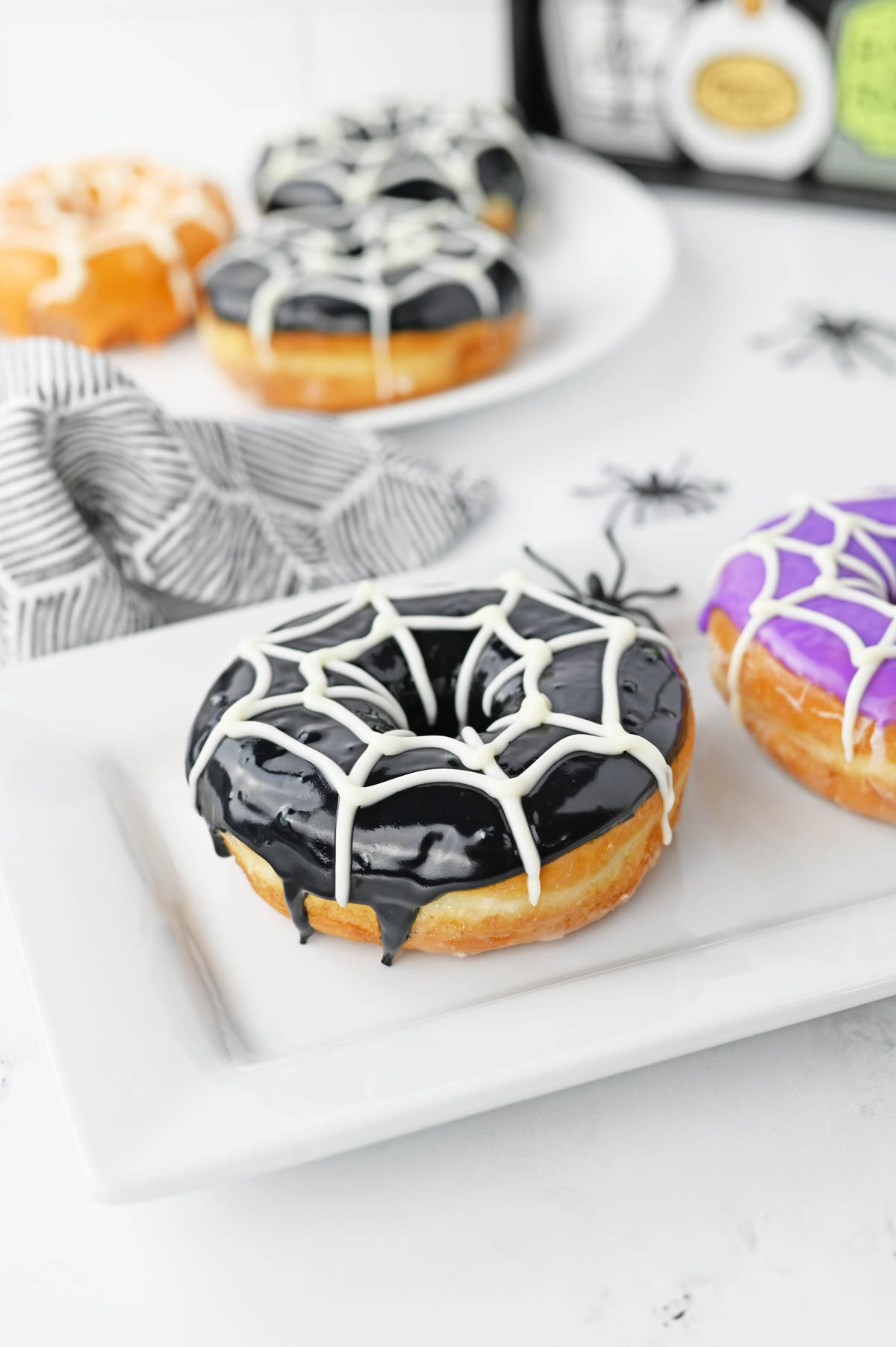 Halloween donut with black icing and white chocolate spiderweb