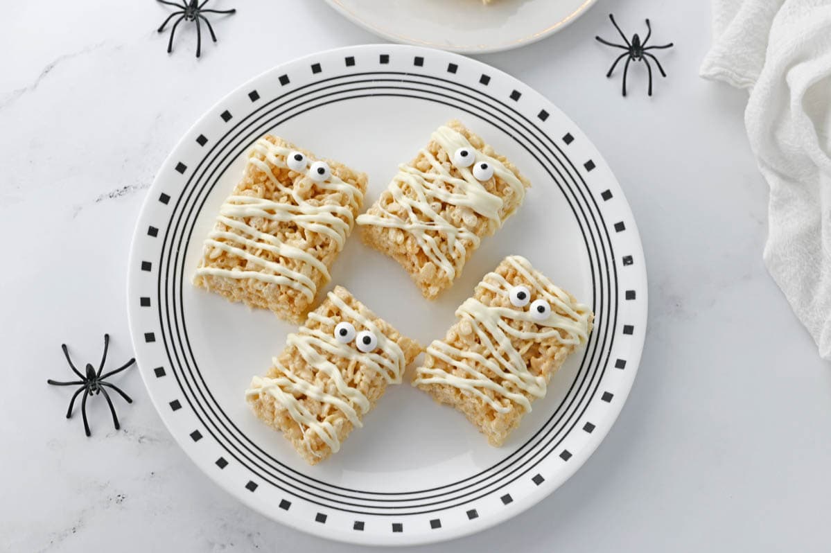 Four mummy treats on black and white plate