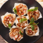 Phyllo cup appetizers on black plate