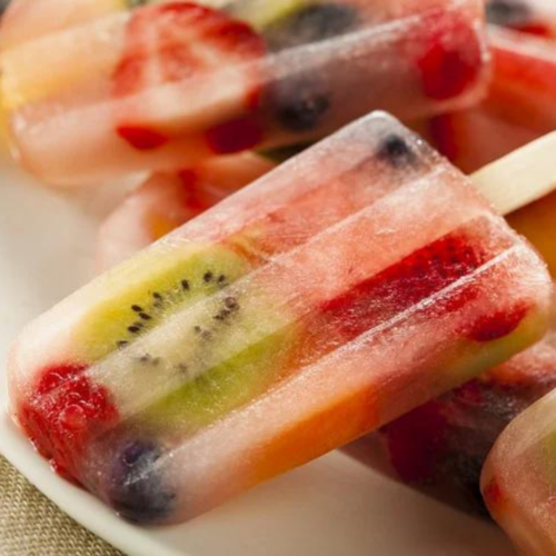 Boozy popsicles with fruit inside on white plate