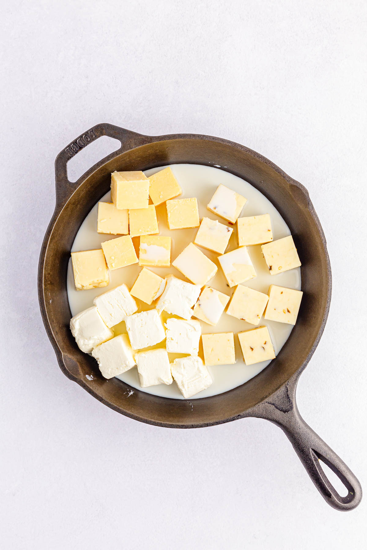 Cheese and milk in cast iron skillet