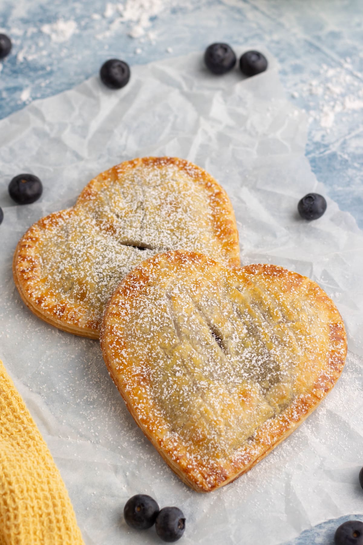 Blueberry hand pies up close on parchment paper