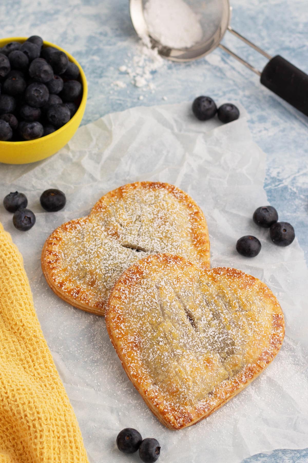 Blueberry hand pies on piece of parchment paper