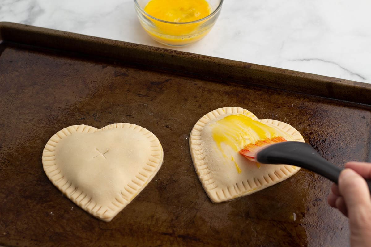 Brushing pie crust with egg