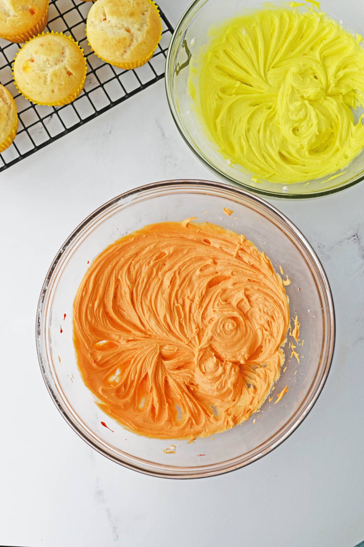 Buttercream frosting colored yellow and orange