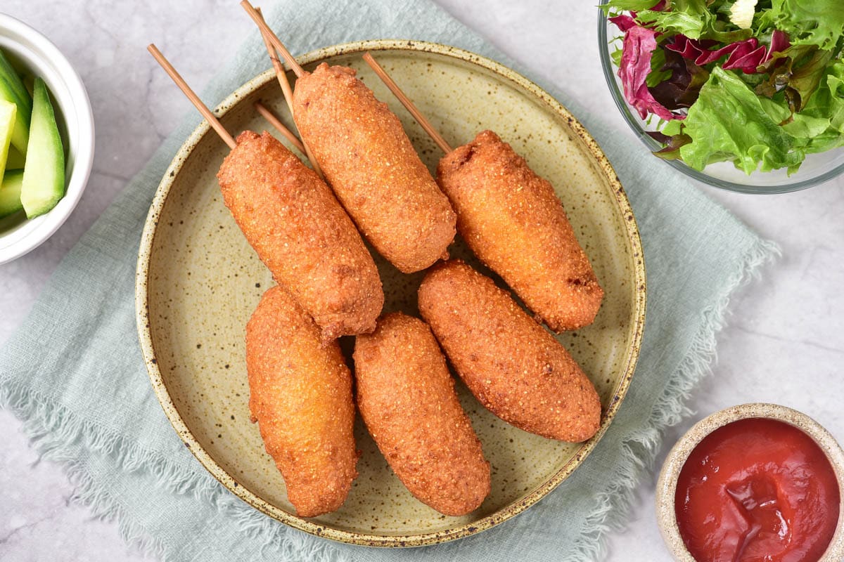 Corn dogs on yellow plate