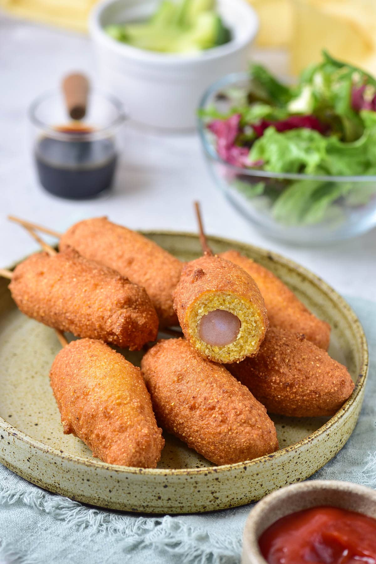 Corn dogs, one with a bite taking out