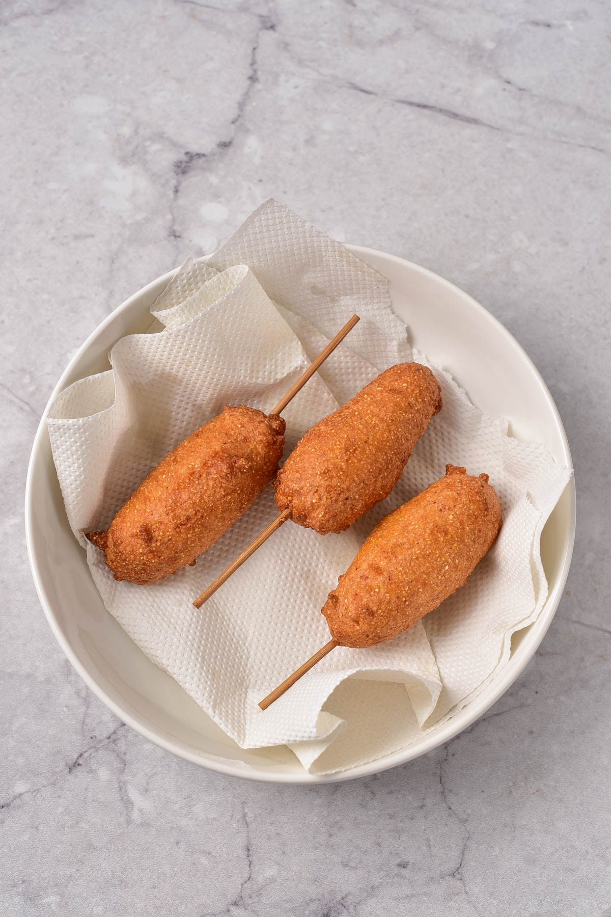 Corn dogs drying out on paper towel