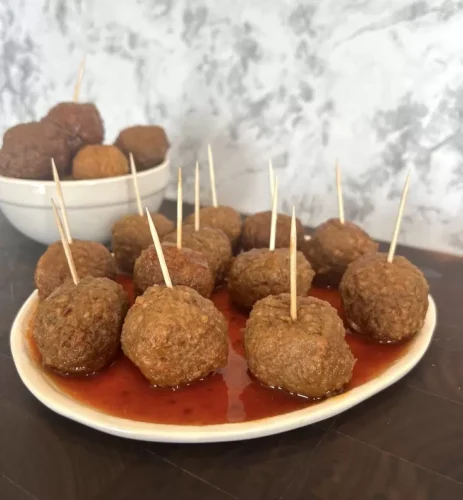 Drunken meatballs on plate with toothpicks