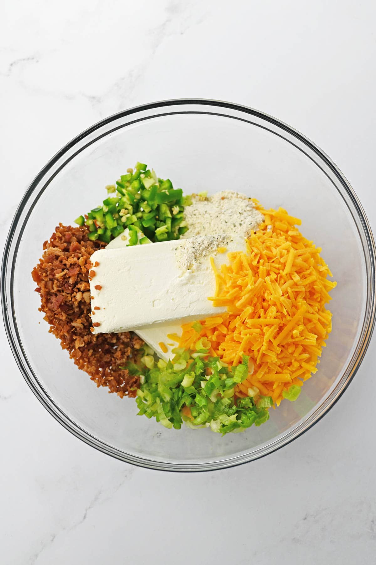 Cheese ball ingredients in clear bowl