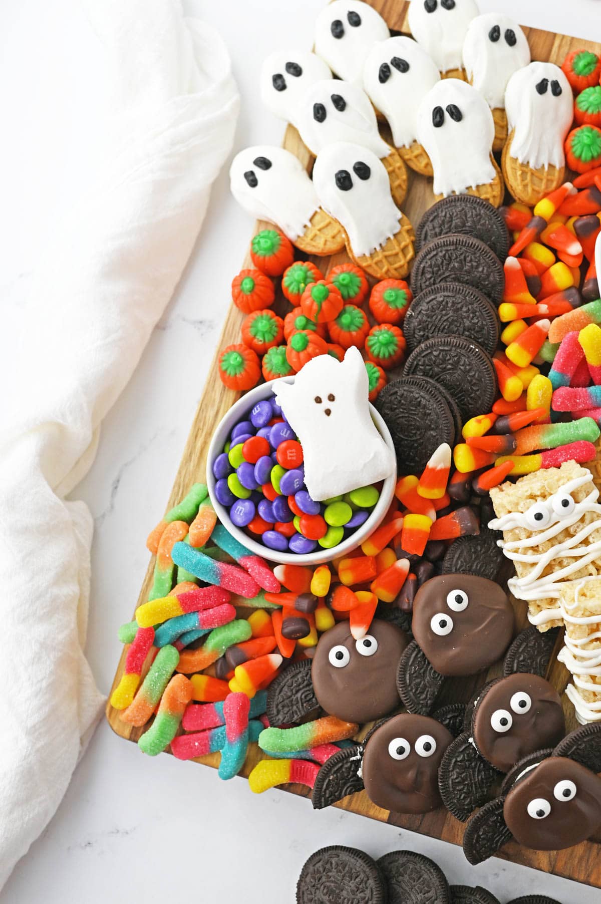 Cookies ghosts and bats with other Halloween candy and food