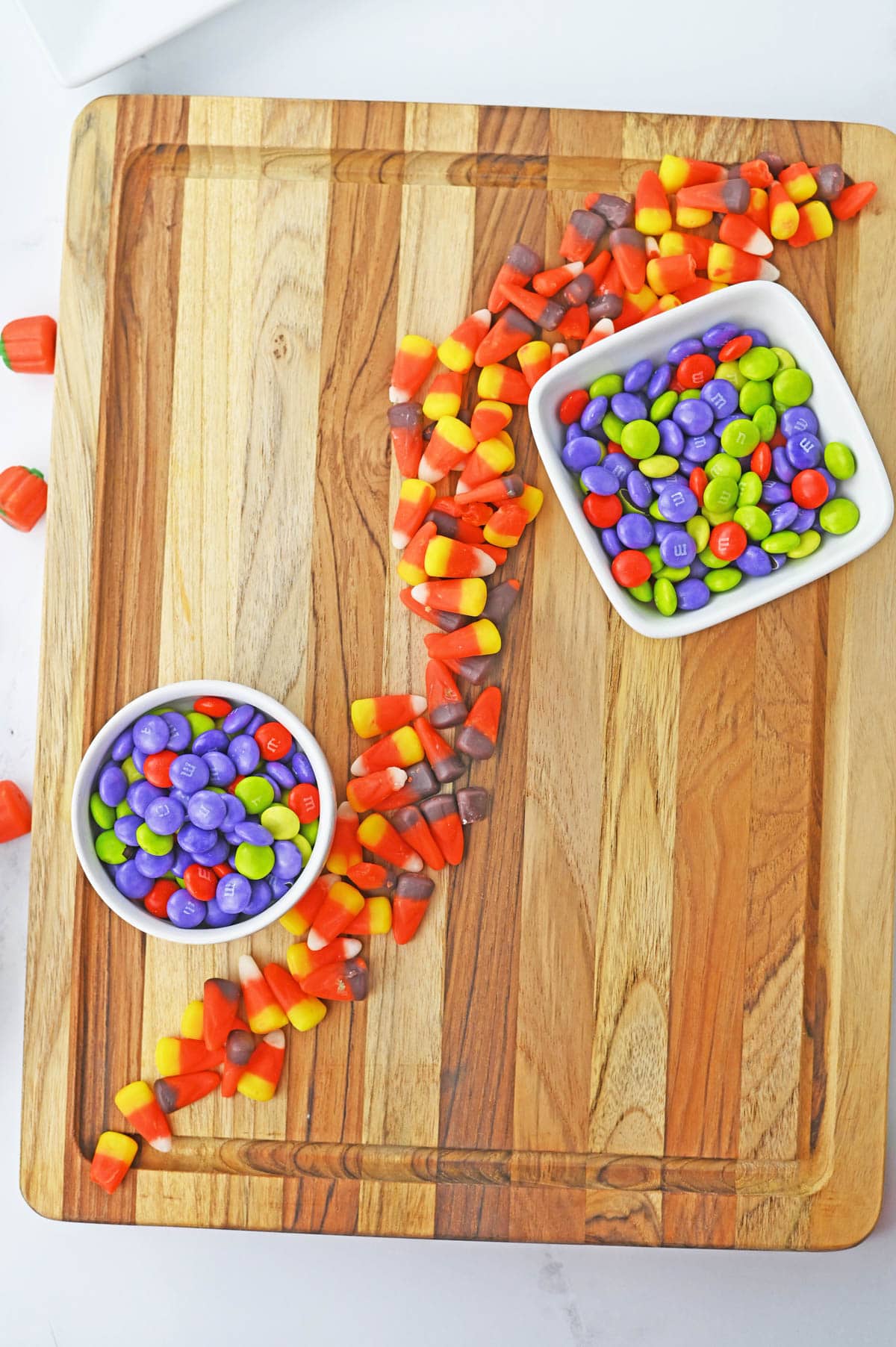 Candy corn on a wooden cutting board