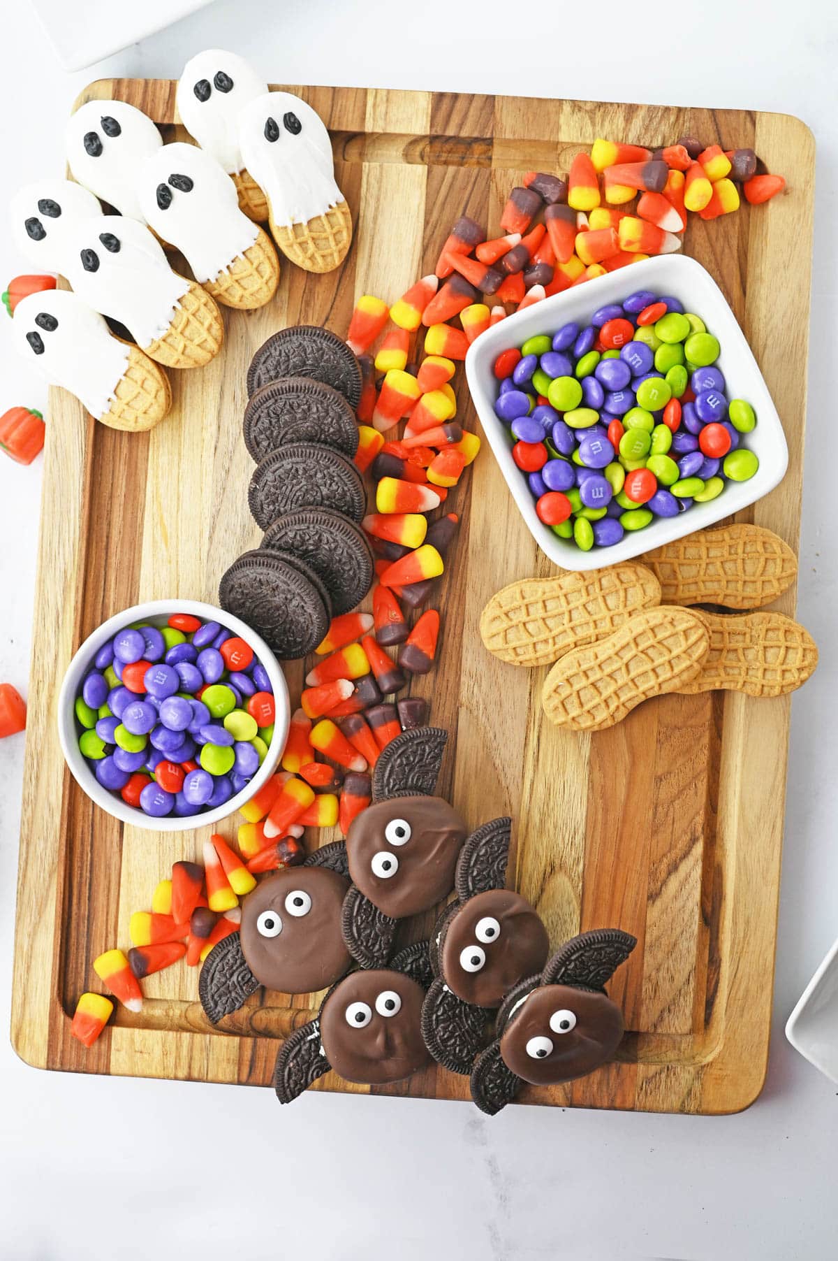 Halloween snack board with cookies and candy corn
