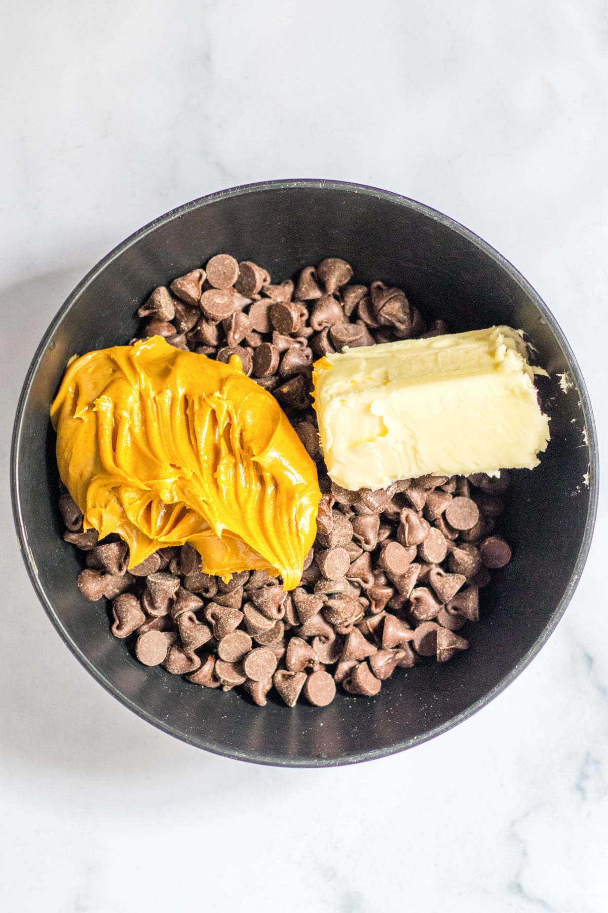 Chocolate chips, butter and peanut butter in bowl