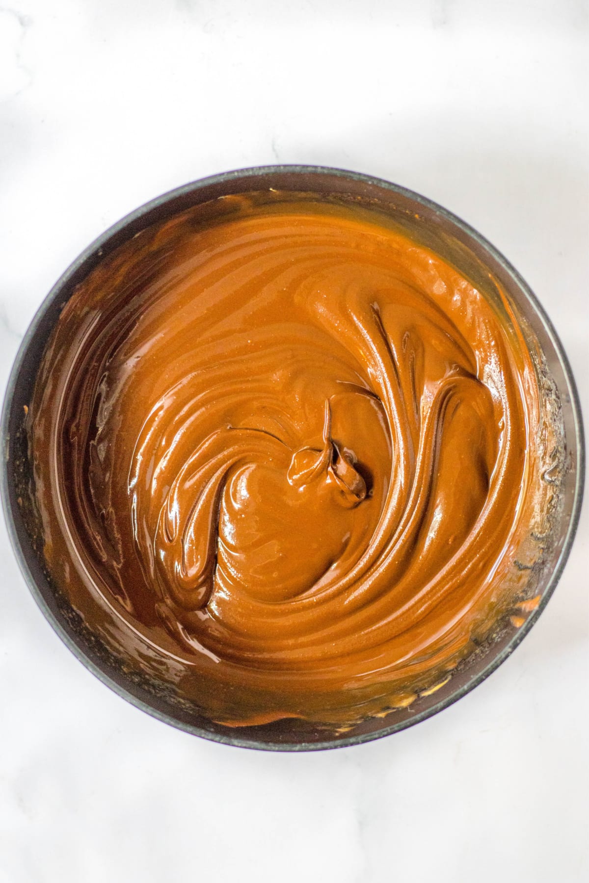 Chocolate and peanut butter mixture melted together in mixing bowl