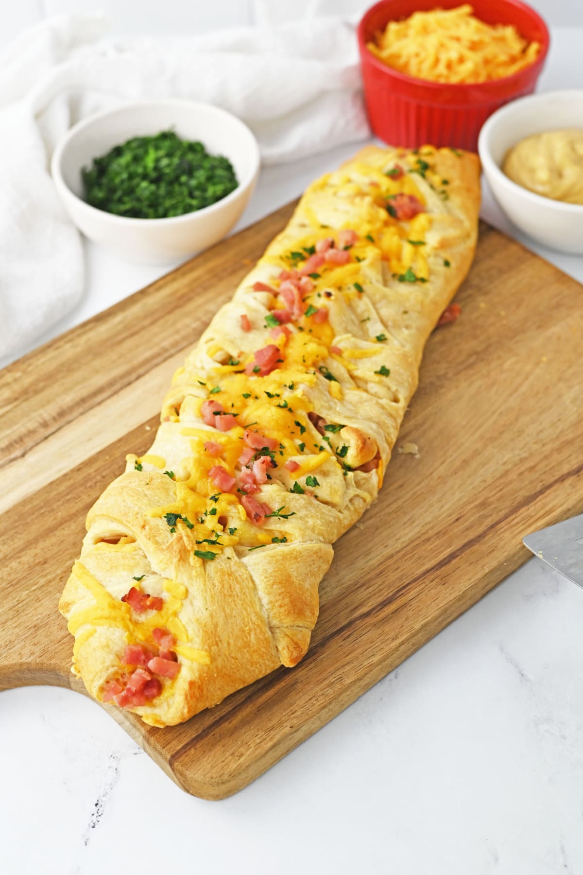 Ham and Cheese crescent braid on wooden board