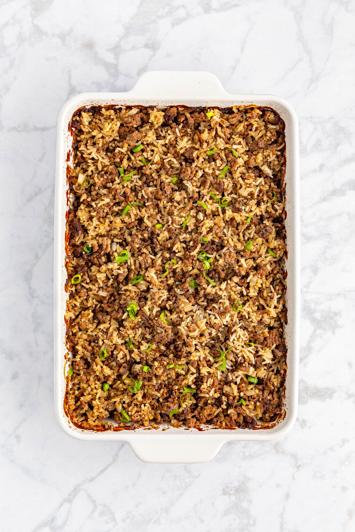 Hamburger rice casserole topped with green onions