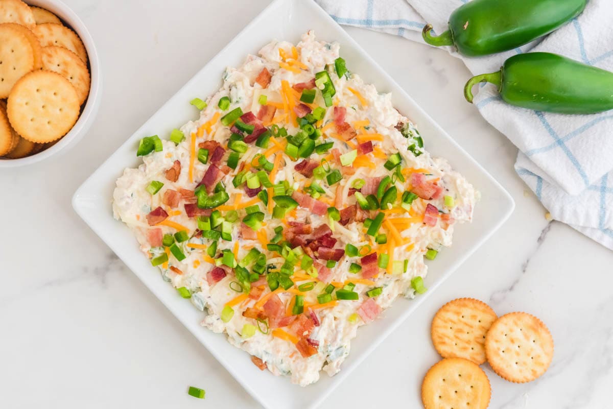 Jalapeno popper dip with crackers and jalapeno poppers