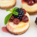 Mini cheesecake with cherry and blackberry on a plate