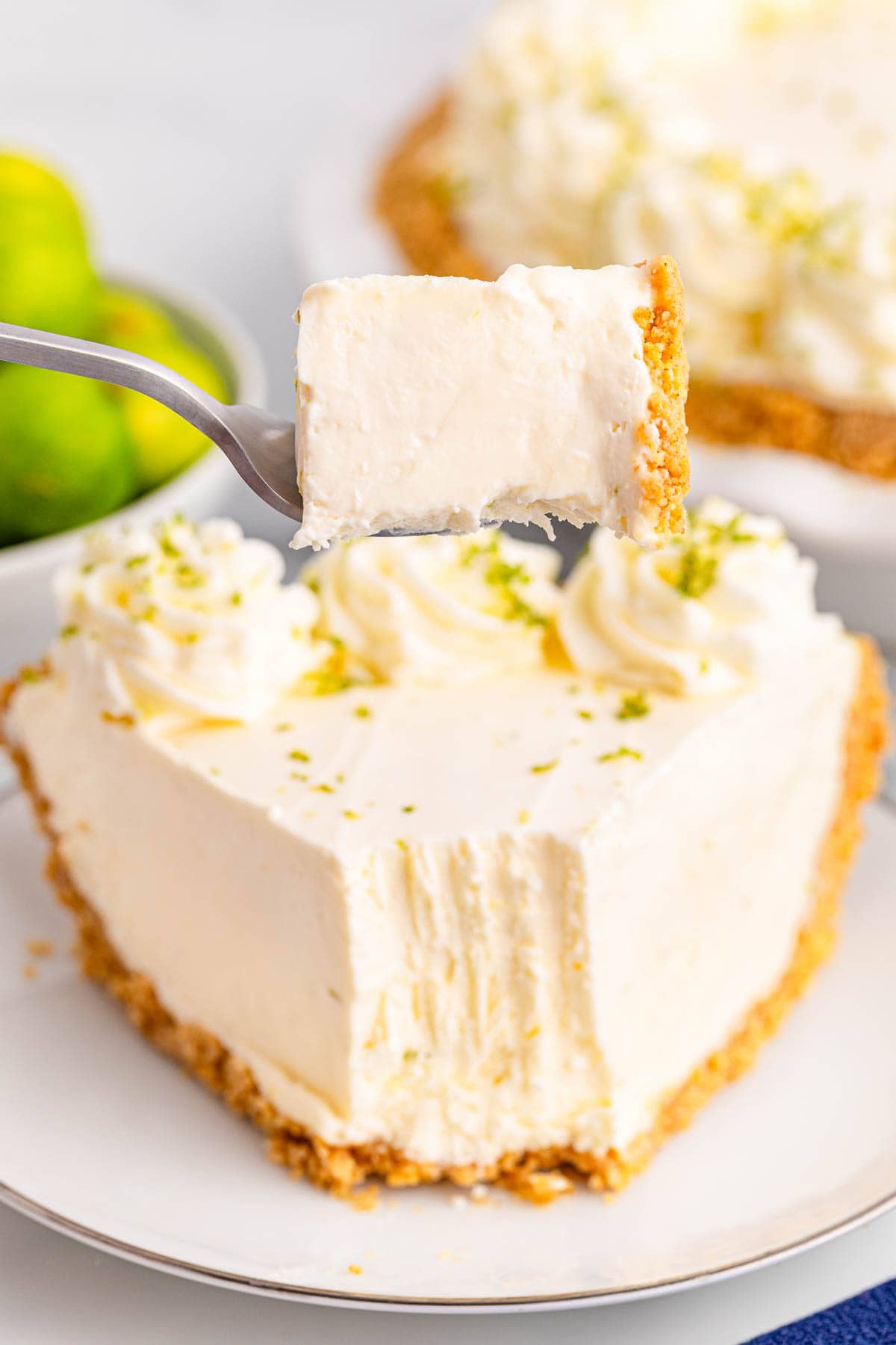 A bite of key lime pie on a fork