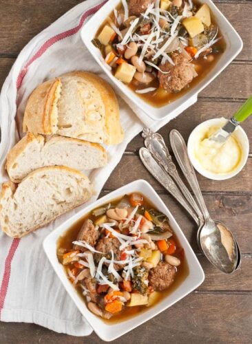 Slow cooker minestrone soup in white bowls