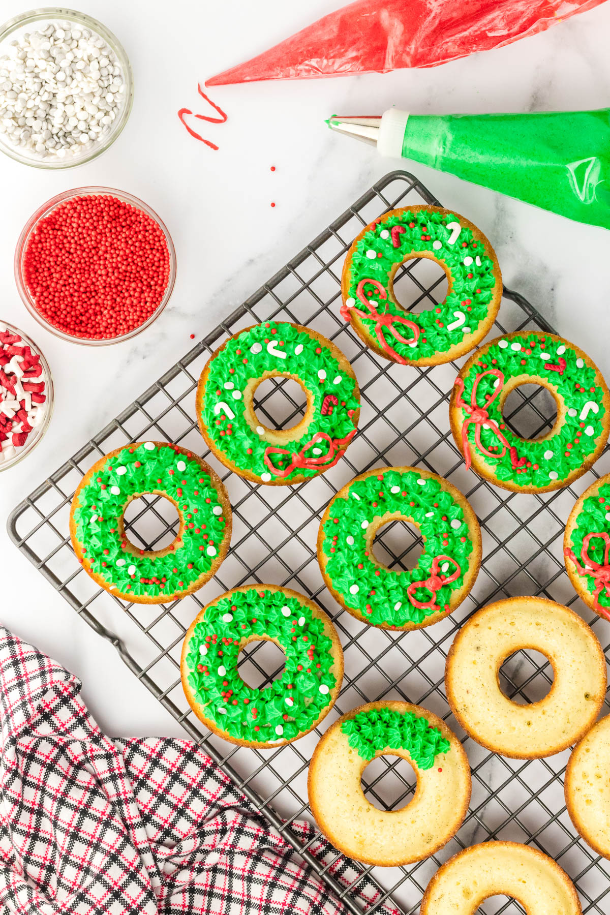 Christmas donuts on a cooling rack with green and red icing
