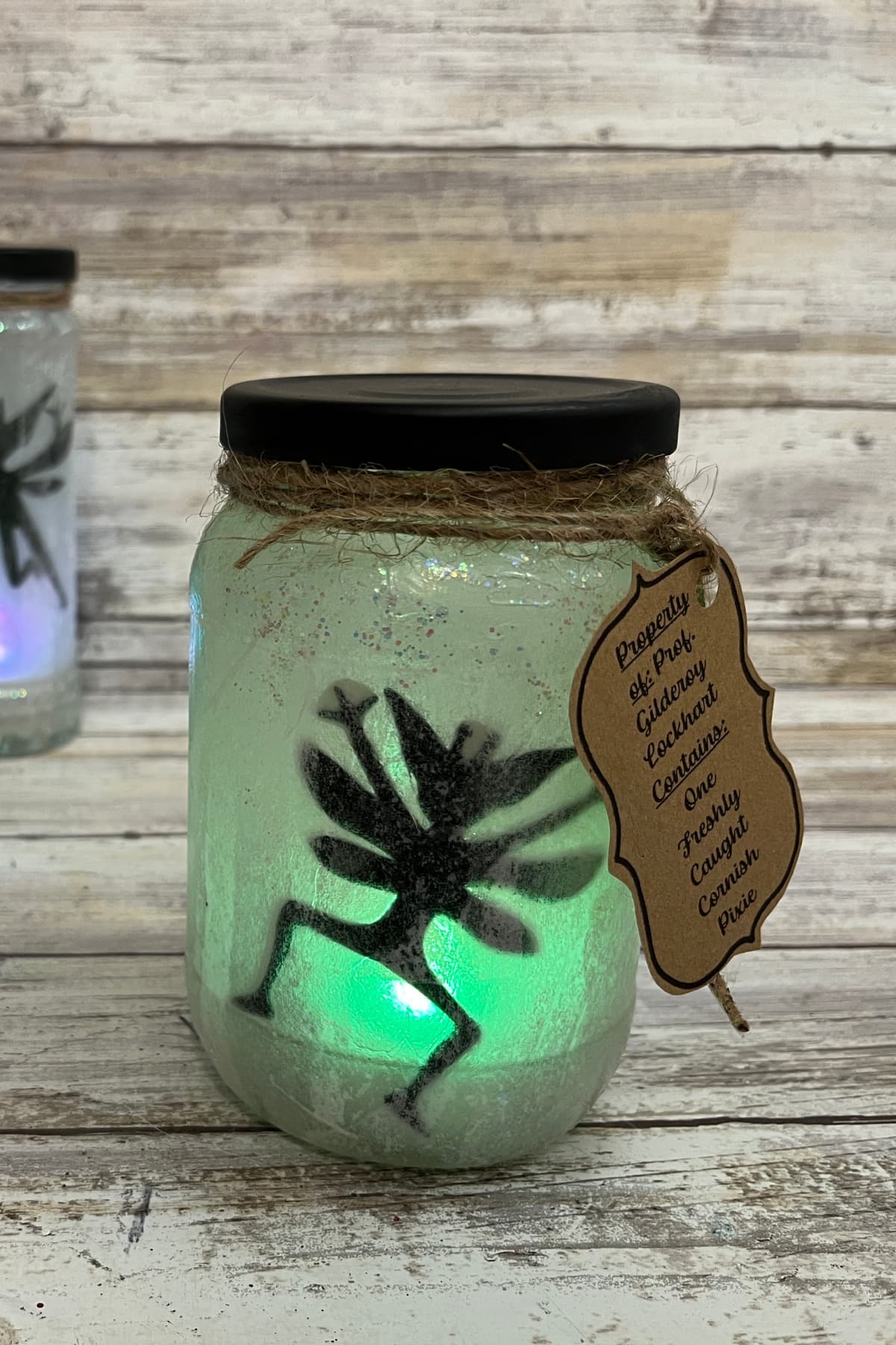 Cornish pixie jar with green light