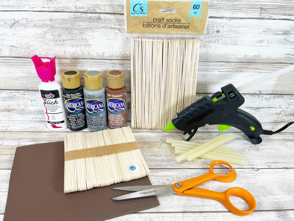 Craft supplies including glue sticks, scissors and paint.