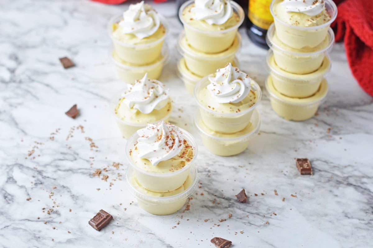 Lemon mousse cups with whipped cream and chocolate chips.