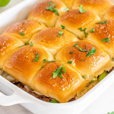 A casserole dish with sliders in it.