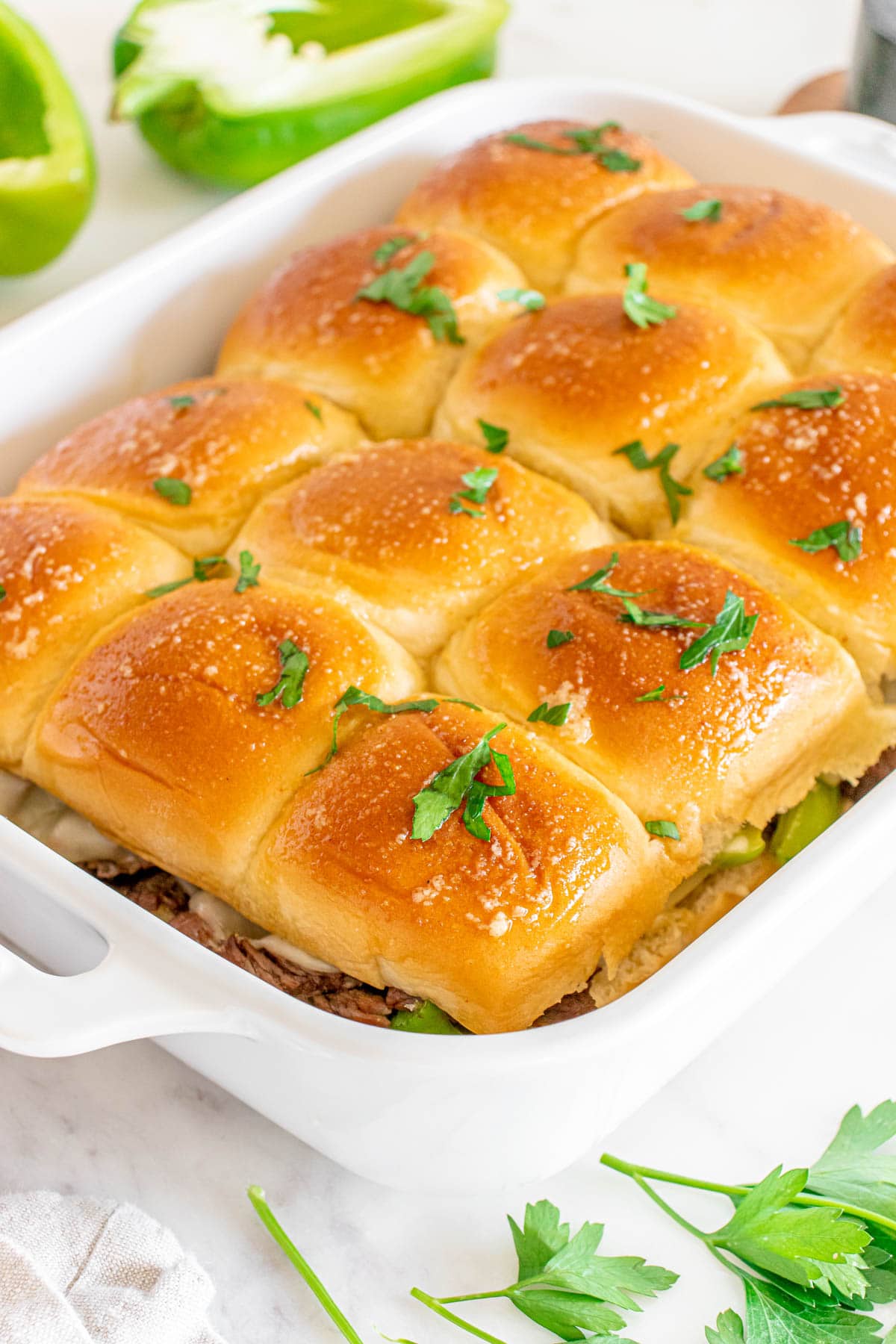A casserole dish with sliders in it.