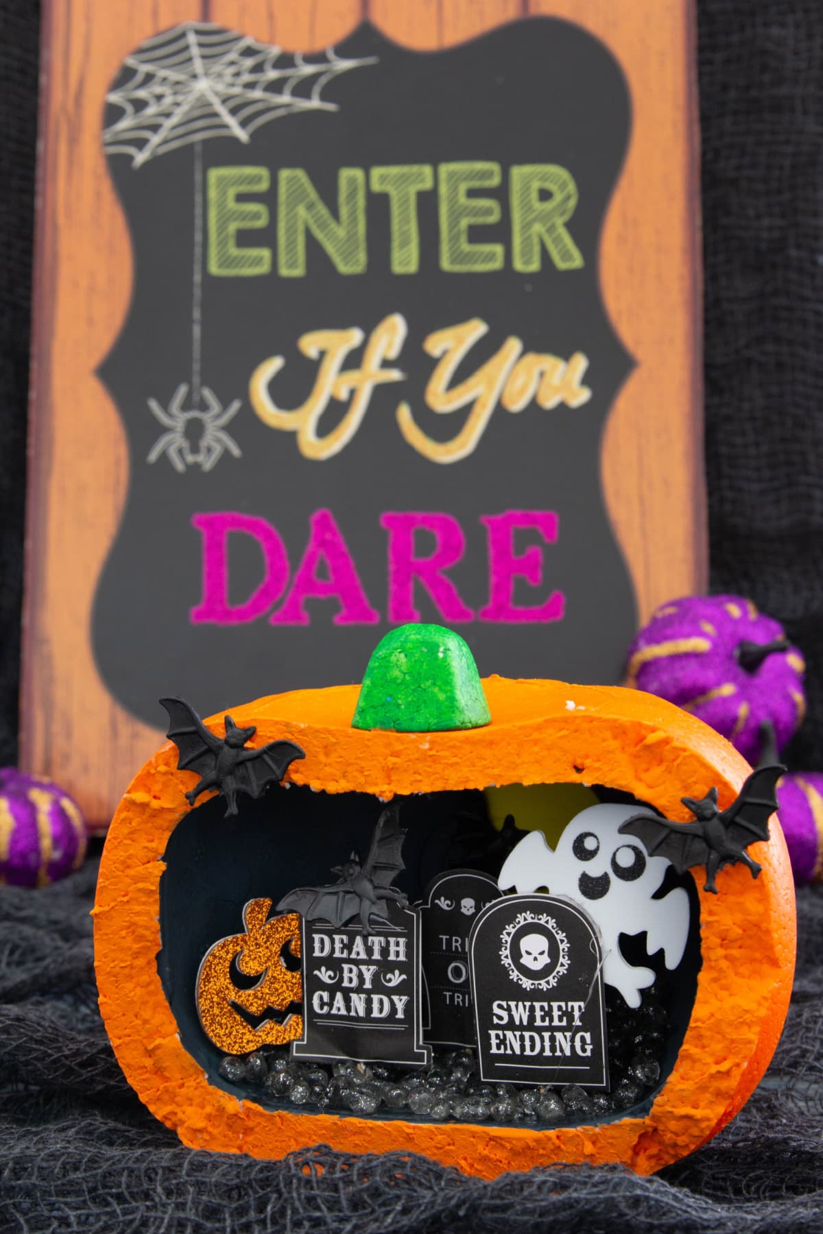 A pumpkin with a sign that says enter if you dare.