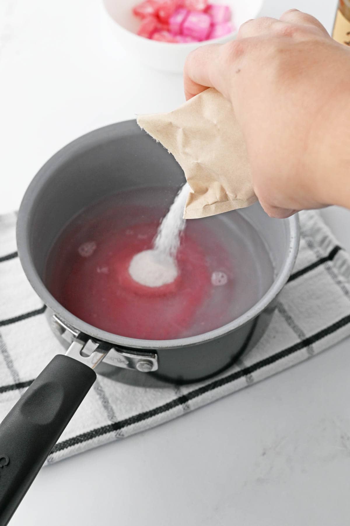 A person pouring jello into a pan.