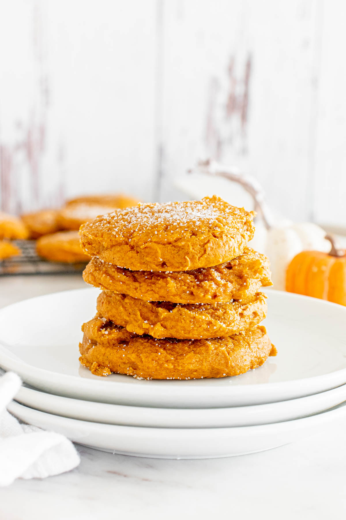 A stack of 3 ingredient pumpkin cookies on a white plate.