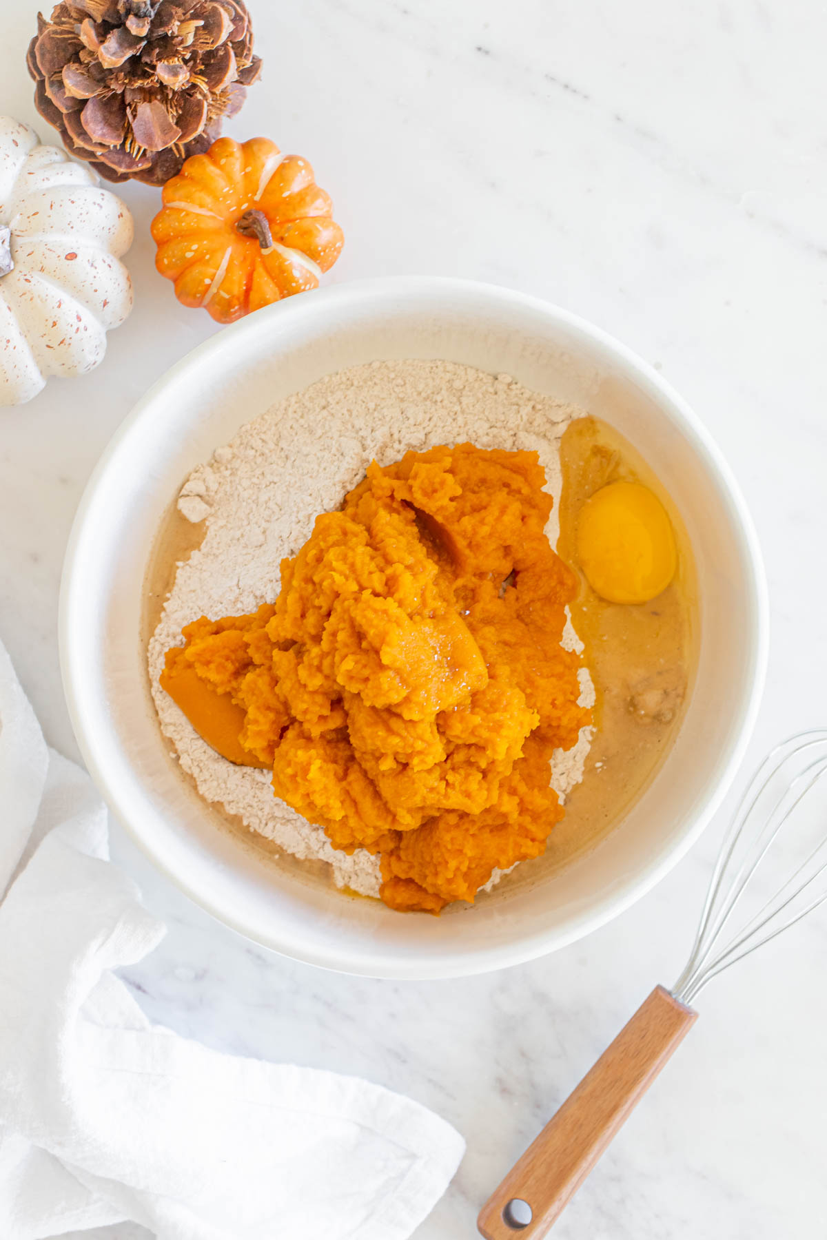 A bowl with ingredients for pumpkin cookies