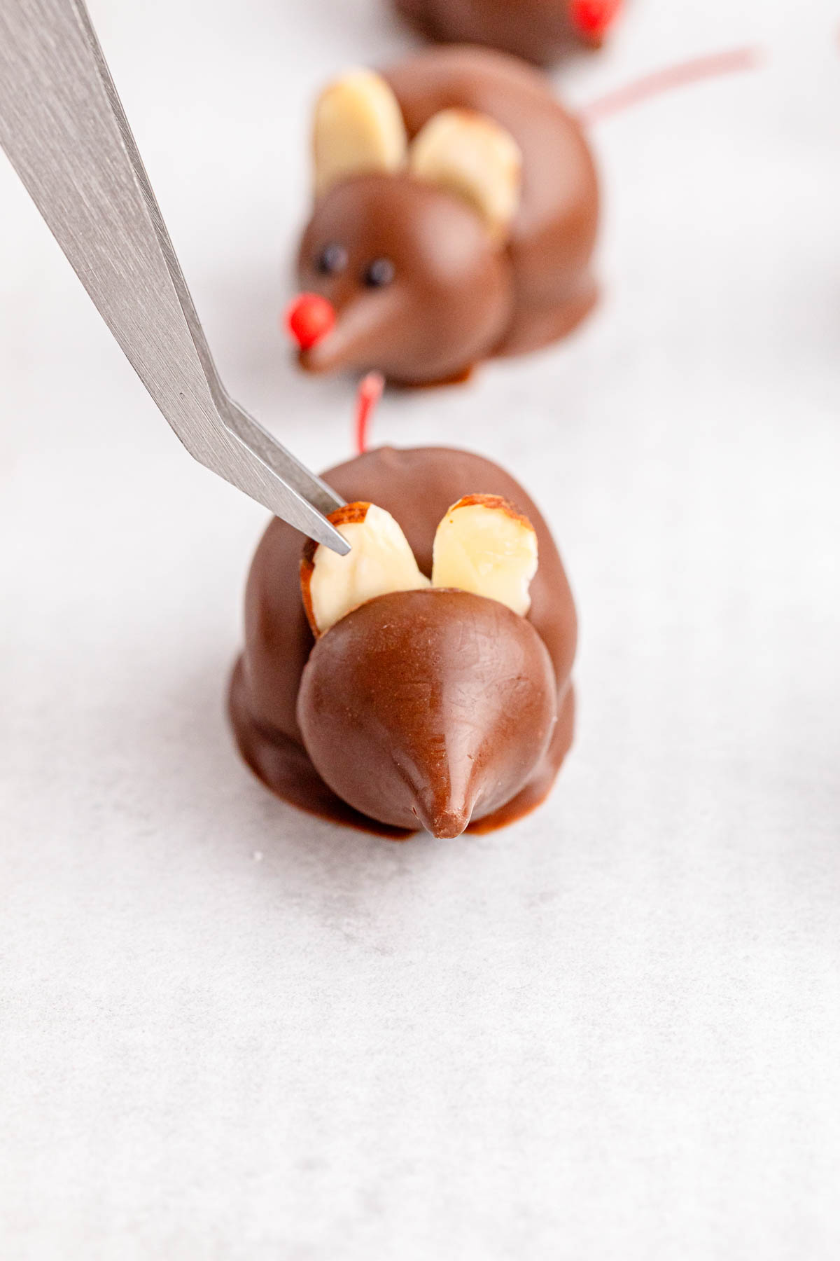 Adding almond slice ears to a chocolate mouse