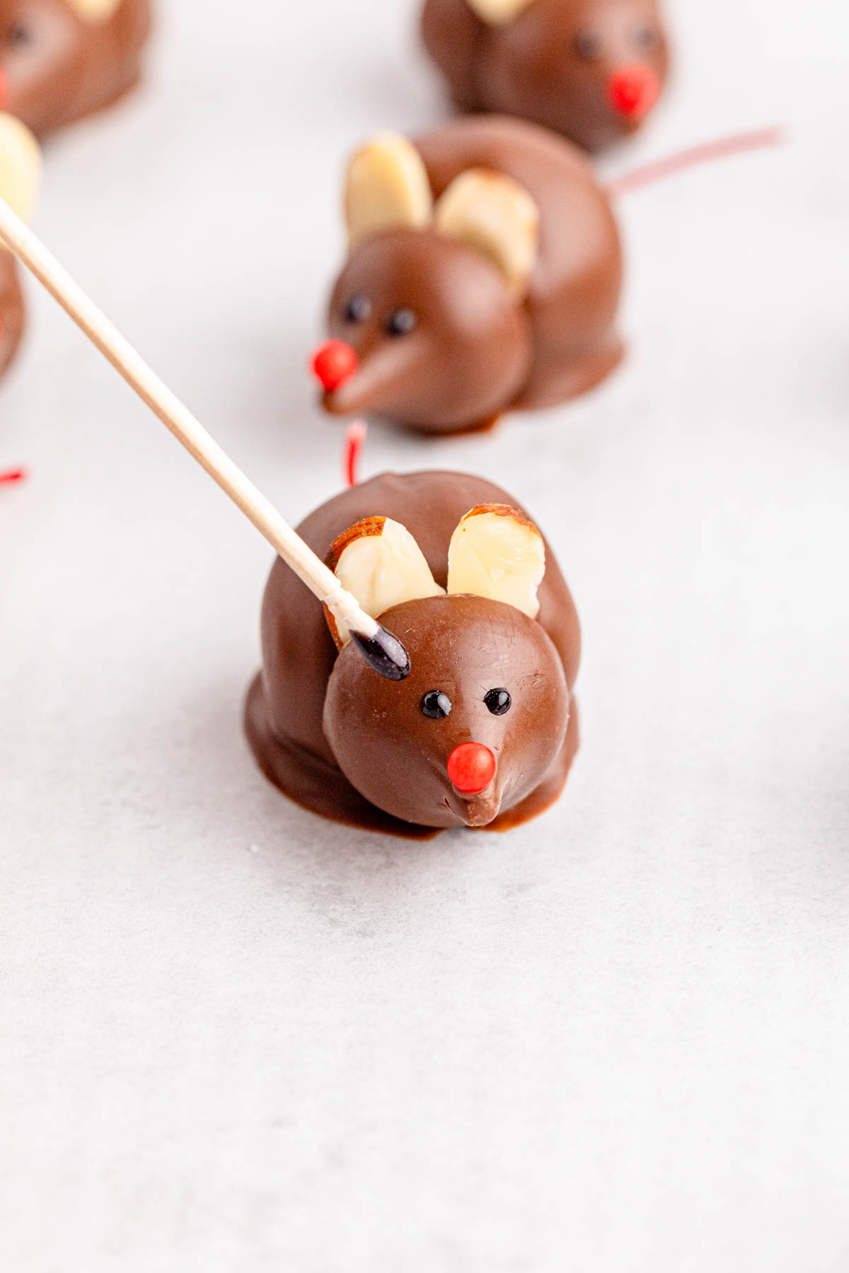 Black eyes being added to a chocolate mouse