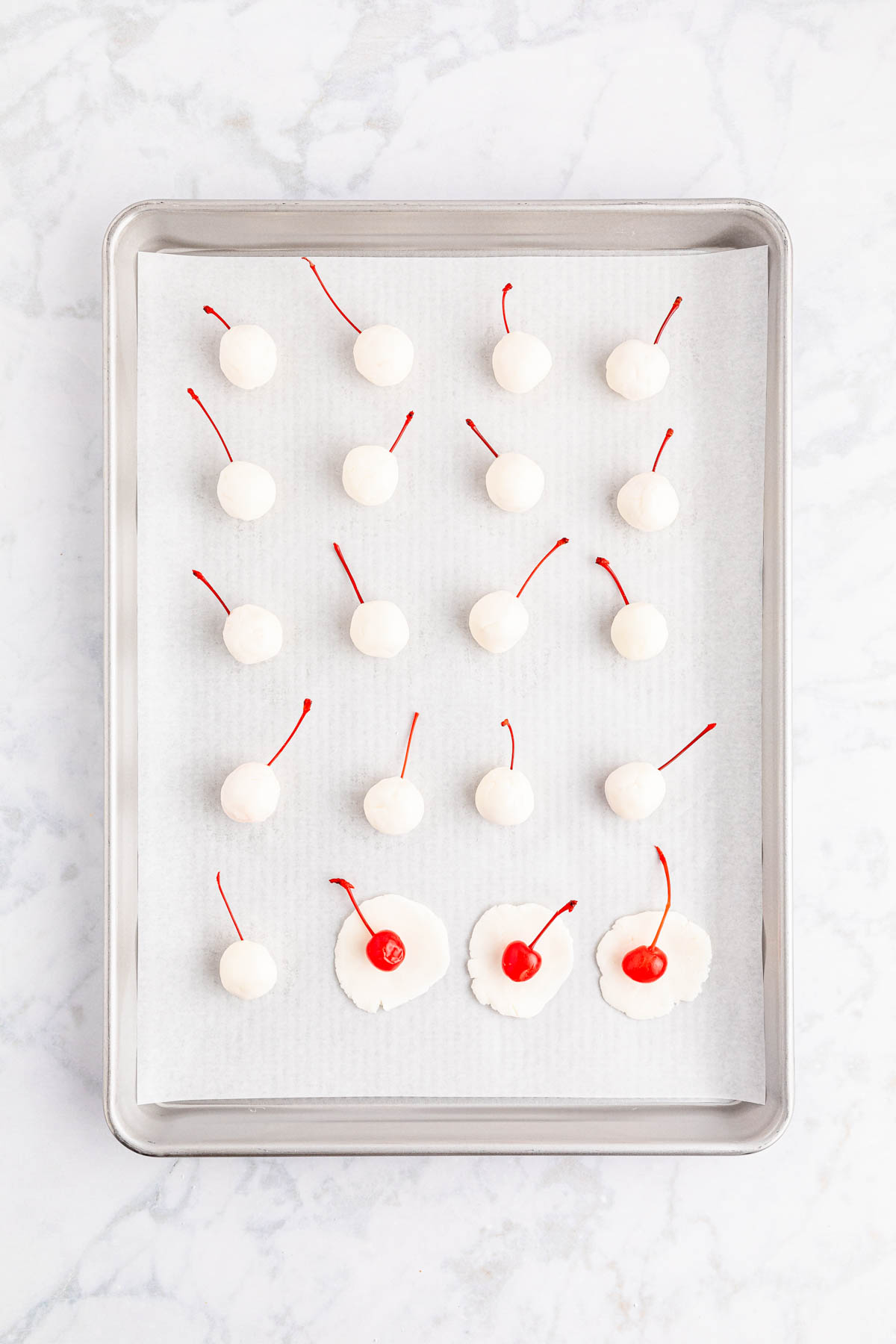 Cherries on a baking sheet with sugar circles