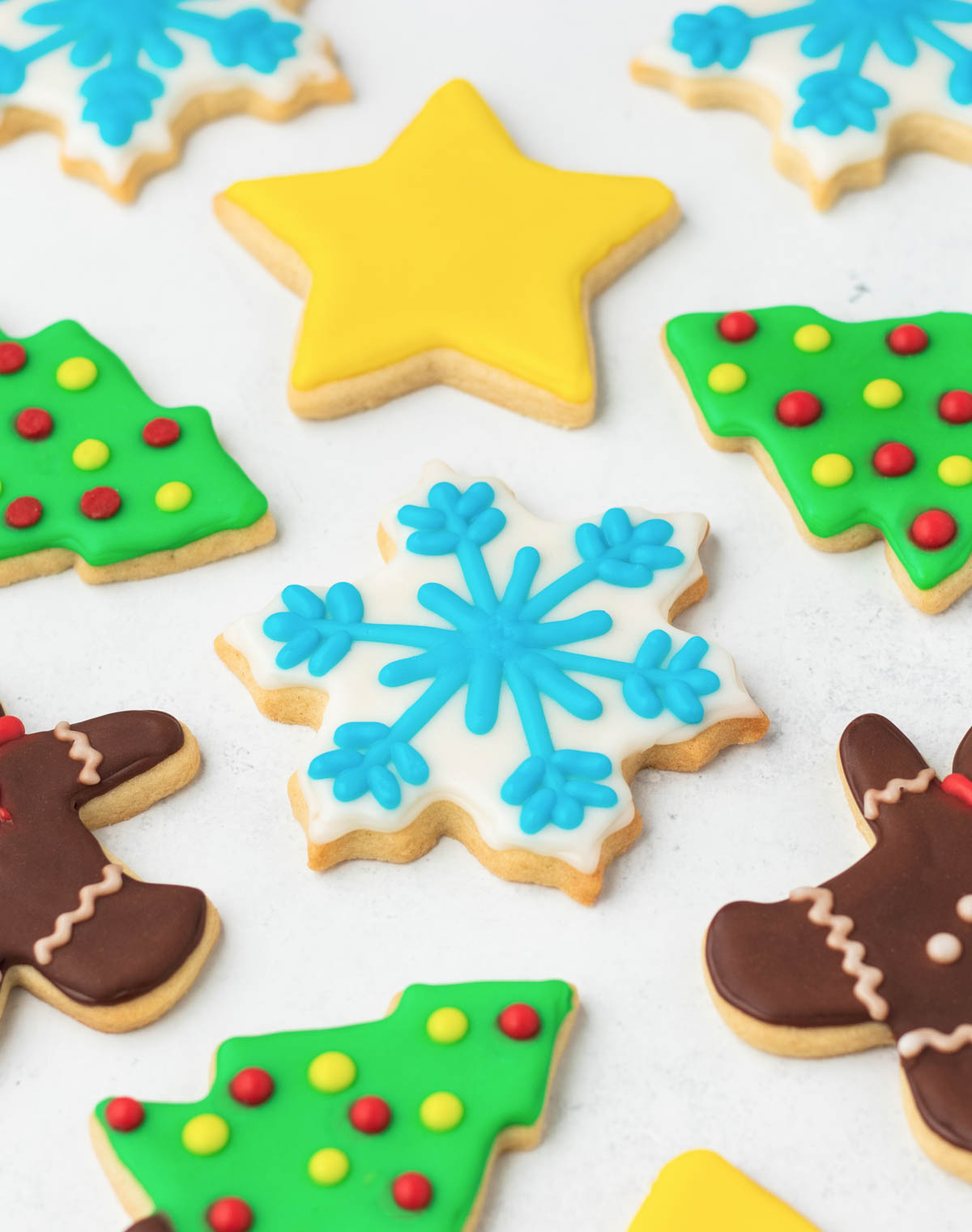 Christmas cookies decorated with gingerbread men, snowflakes, and stars.
