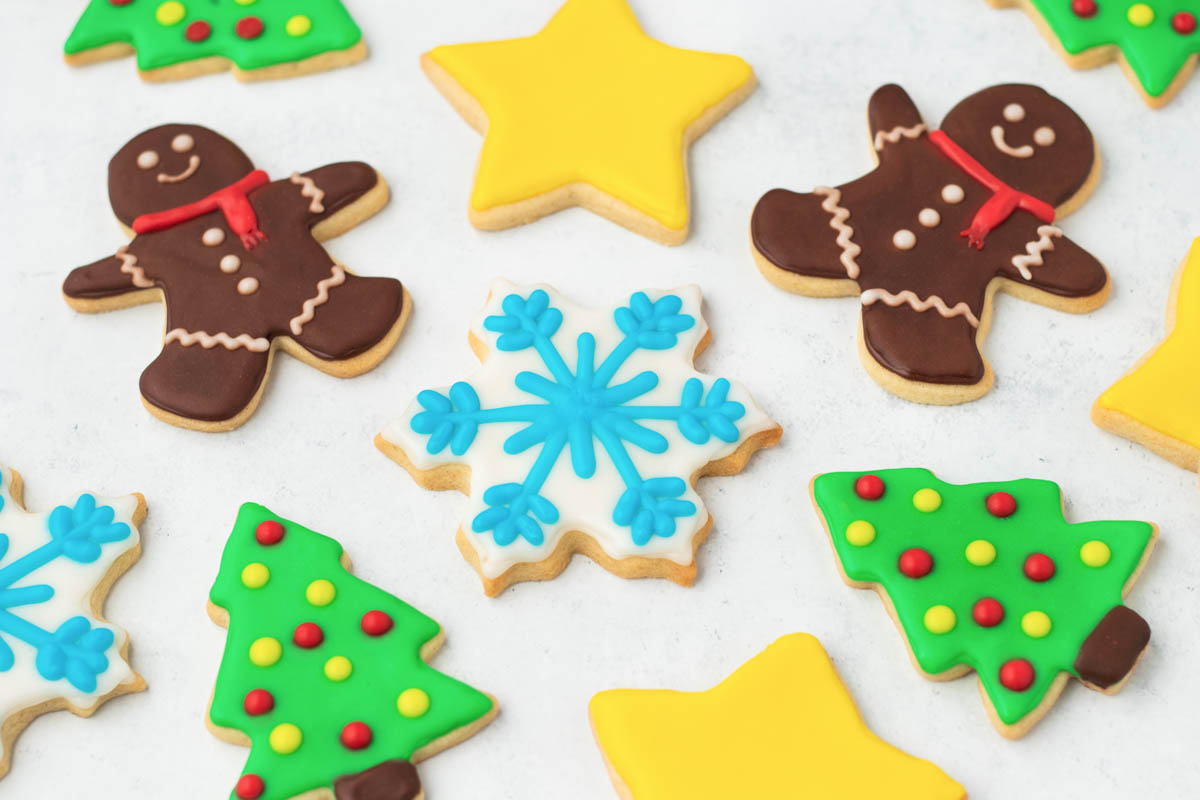 A group of decorated christmas cookies on a white surface.