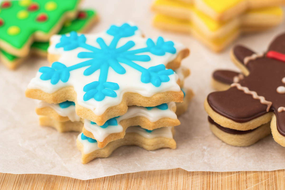 A stack of decorated christmas cookies on a table.