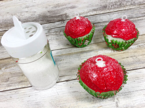 Christmas cupcakes with sprinkles and a salt shaker.