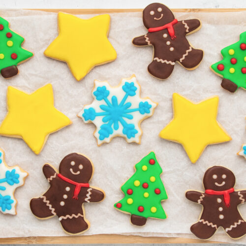A tray of decorated christmas cookies on a baking sheet.
