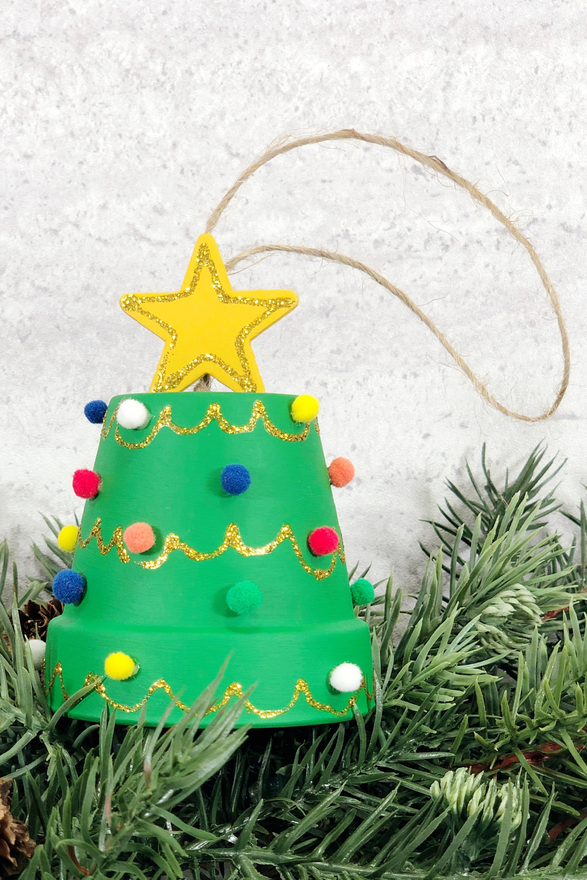A green christmas tree ornament with a star on it.
