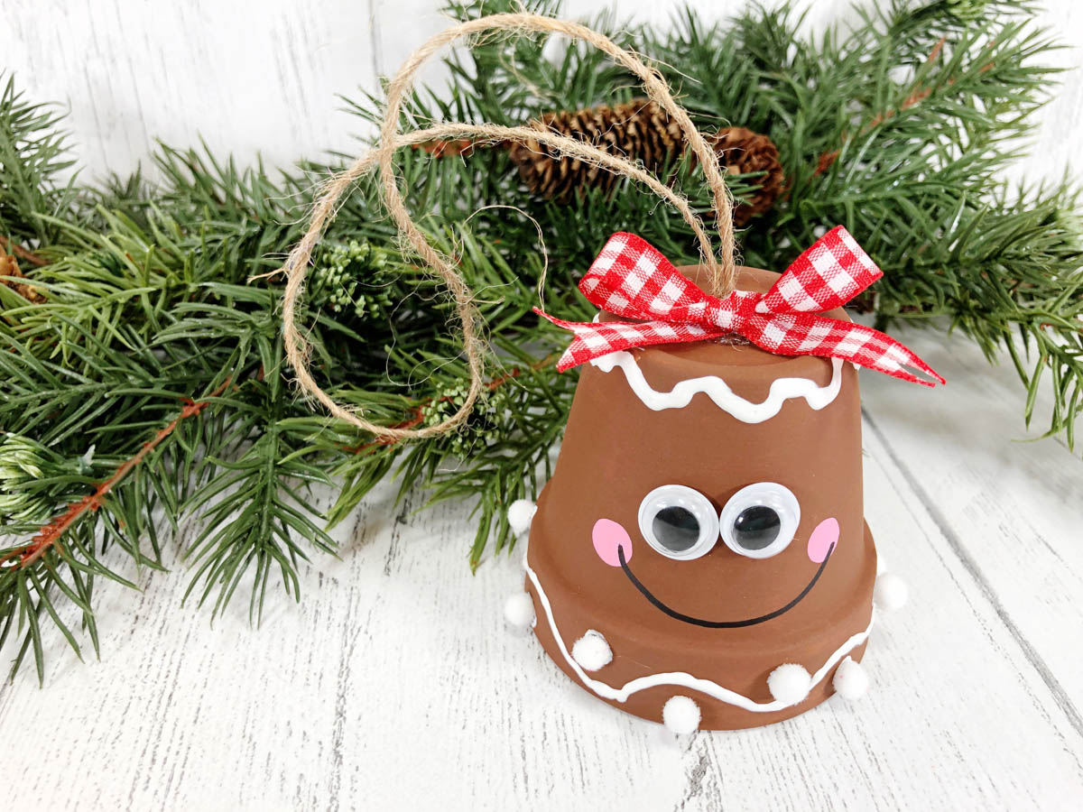 A christmas ornament with a gingerbread face on it.